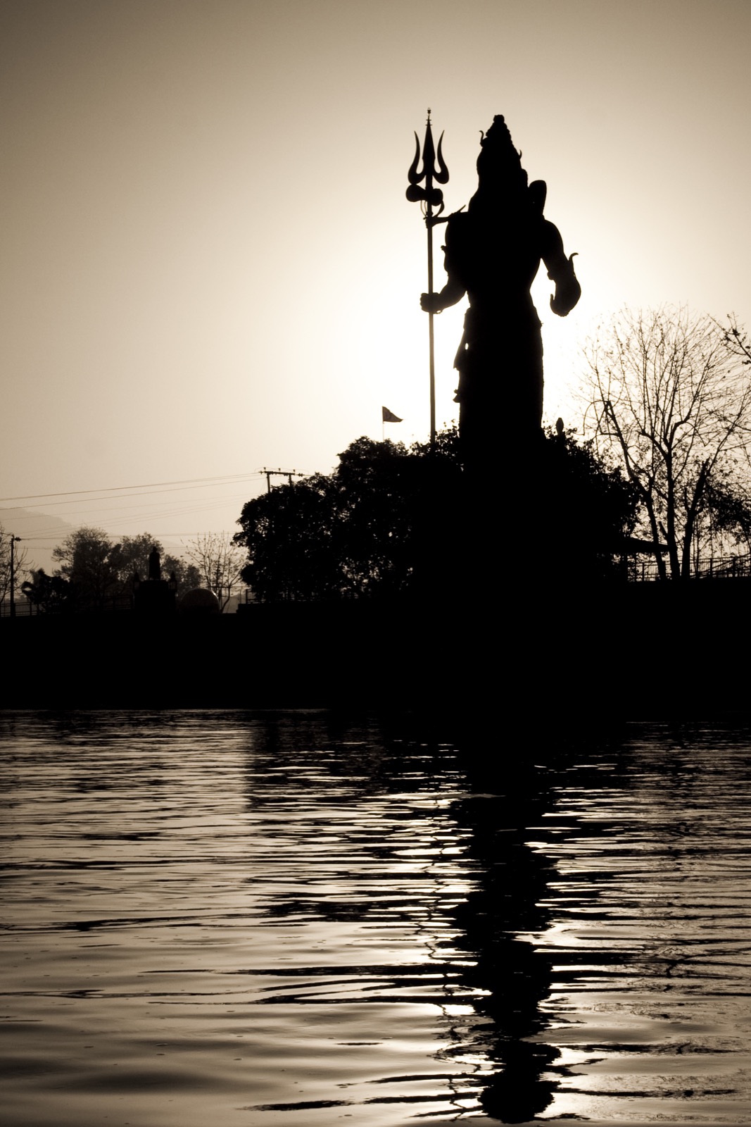 Shiva statue silhouette near Har Ki Pauri at sunrise